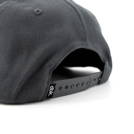 Charcoal snapback cap side with adjustable snapback strap and dbk label