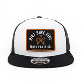 White front trucker cap with embroidered biker patch and black mesh side panels