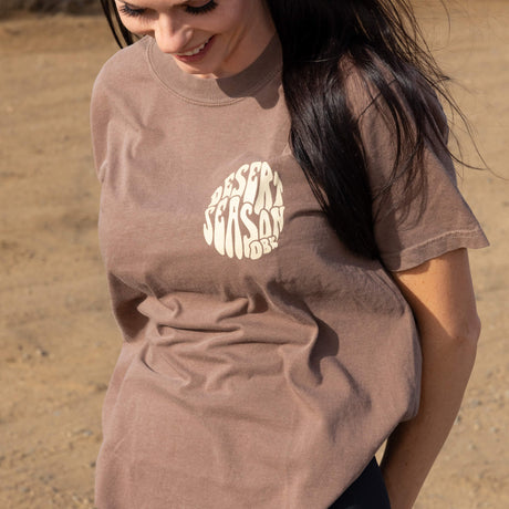 Brown womens crew-neck T-shirt with Desert Season logo printed on back