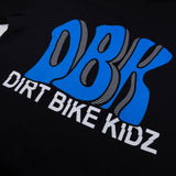 Black tee close-up of blue DBK graphic with striped outline details.