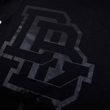 Youth premium tee, close-up of black front logo with dark gray block letters