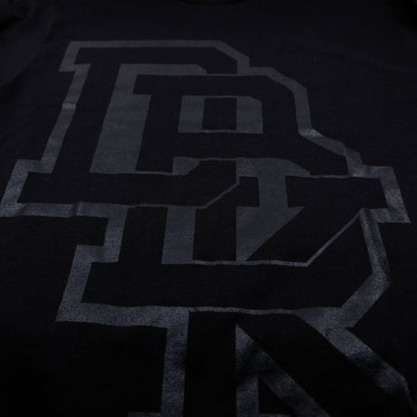 Pitch Black T-shirt close-up: black with bold gray letter graphic on chest