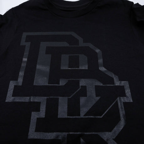 Pitch Black T-shirt close-up: black fabric with large gray letter graphic