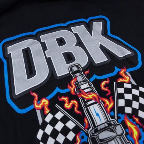 Close-up of DBK wordmark and flames with checkered flag details on black hoodie