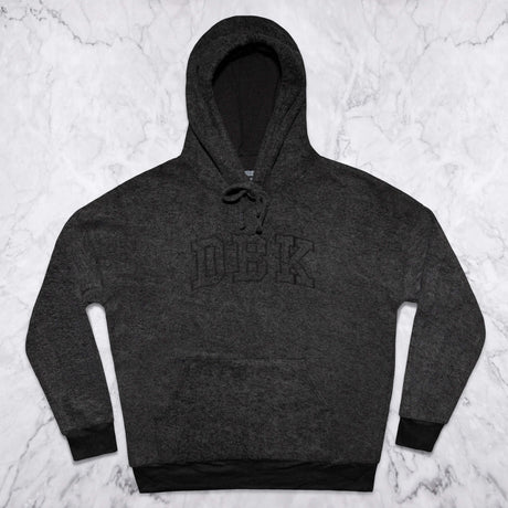 Women’s dark charcoal pullover hoodie flat lay with front logo and drawstring hood