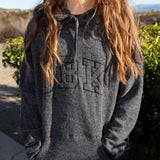 Women’s dark charcoal pullover hoodie with front logo graphic and drawstring hood