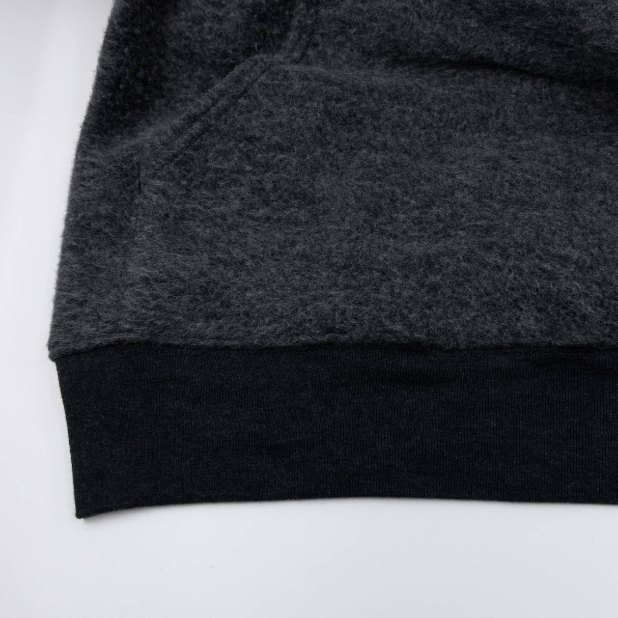 Women’s dark charcoal pullover hoodie sleeve cuff and bottom hem detail