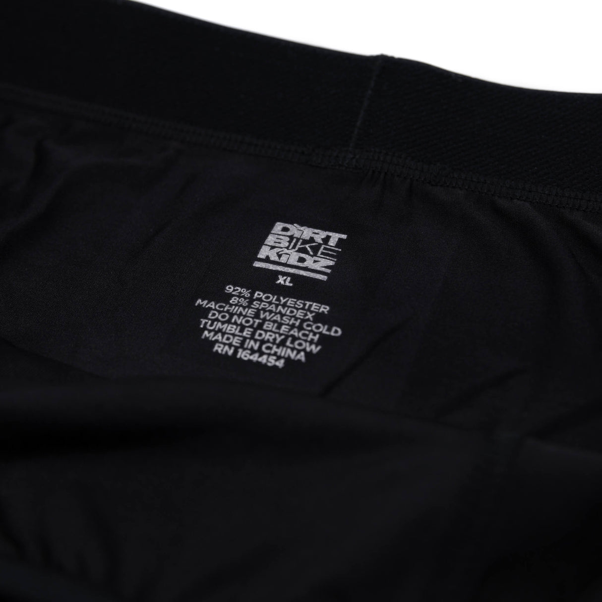 Black boxer briefs care label with sizing and fabric instructions