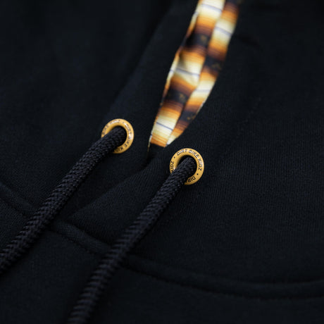 Monte Carlo hoodie drawcord ends and stitched grommets on black fabric
