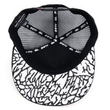 Trucker cap interior view with striped gray mesh top and logo webbing straps