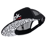 Black mesh trucker cap with patterned white-and-black underside brim panel