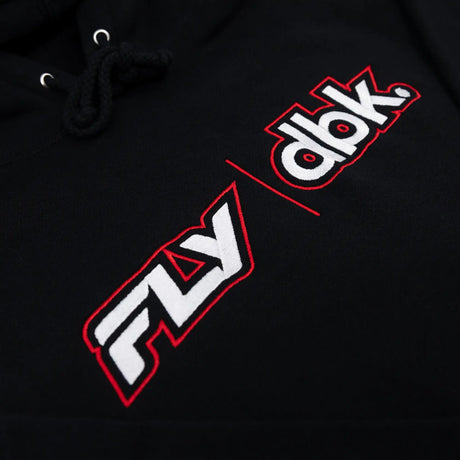 Close-up of black hoodie fabric with diagonal “dbk” logo print