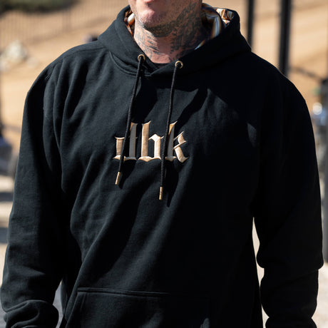 Dark hoodie with hood, front kangaroo pocket, and beige chest logo print