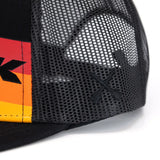 Close-up of black mesh trucker cap side panel and orange-red-yellow front band