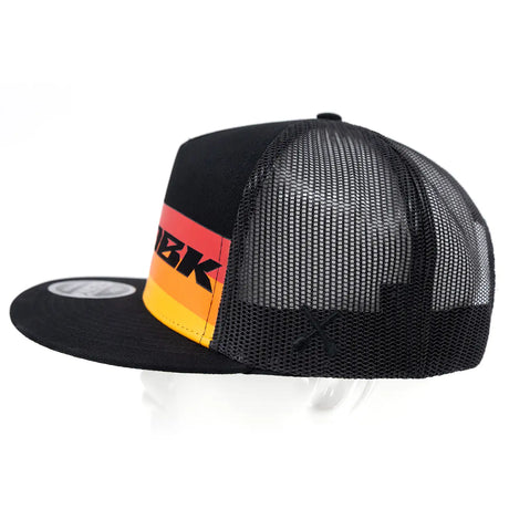 Trucker cap profile view: black brim, black mesh back, DBK logo on stripe