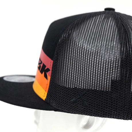 Black mesh back of trucker cap with orange-red logo stripe and curved brim