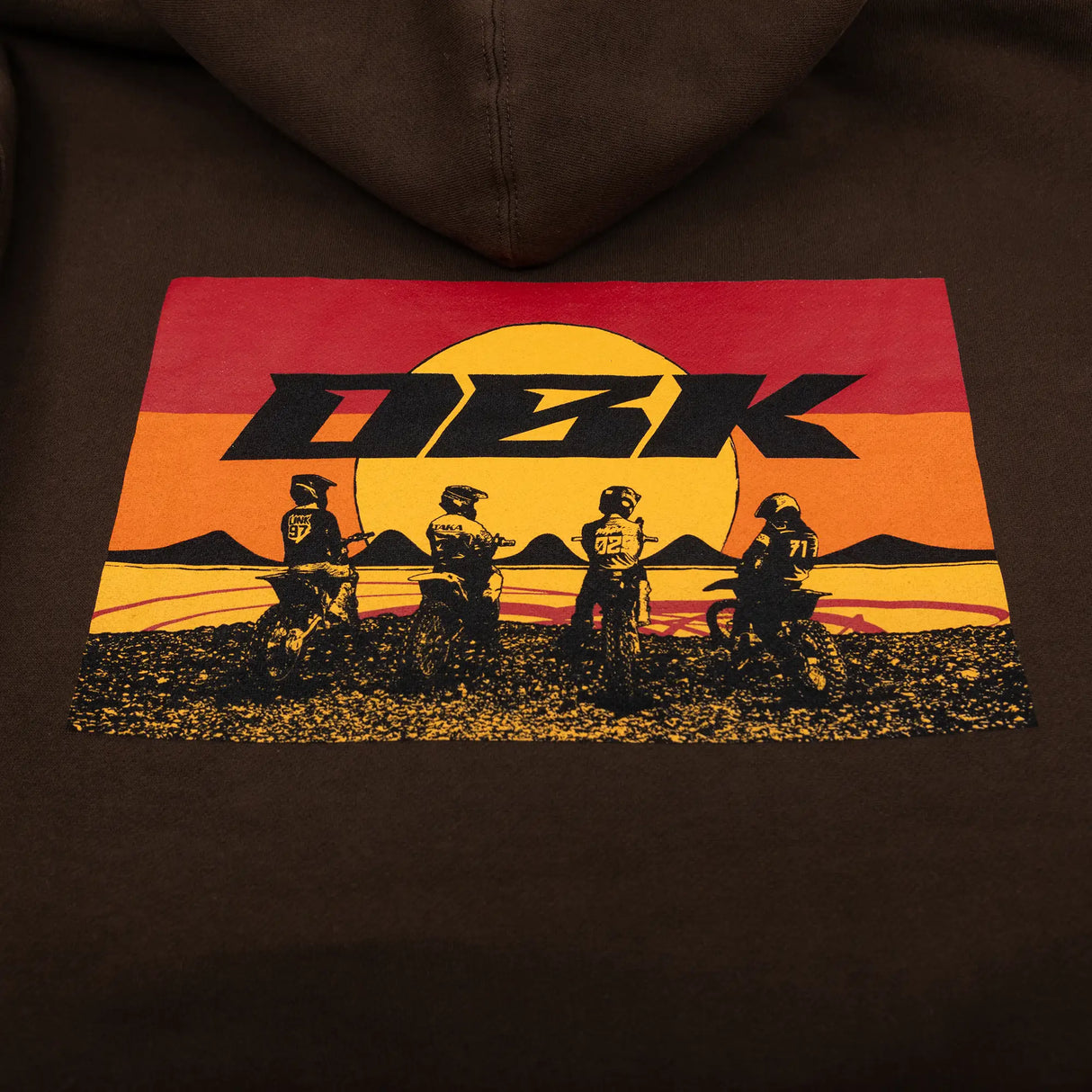 Brown youth hoodie close-up of back graphic with DKB text and silhouettes