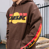 Brown hoodie close-up with yellow front logo and drawstring hood