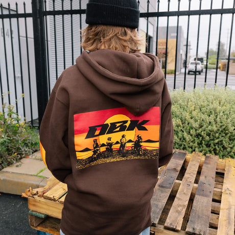 Dark brown hoodie back view with large DBK rider graphic and drawstring hood