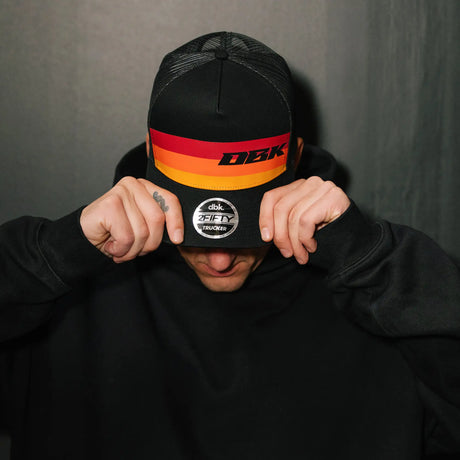 2Fifty trucker cap for kids, black hat with orange-red logo band and front badge