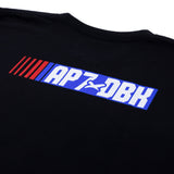 Black youth T-shirt sleeve? chest close-up of blue AP7-DBH striped logo graphic.