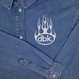 Blue denim shirt logo detail with button placket and cuff at sleeve opening.