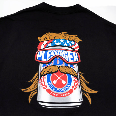 Black youth premium tee with large “PLESSINGER” moto badge and goggles graphic