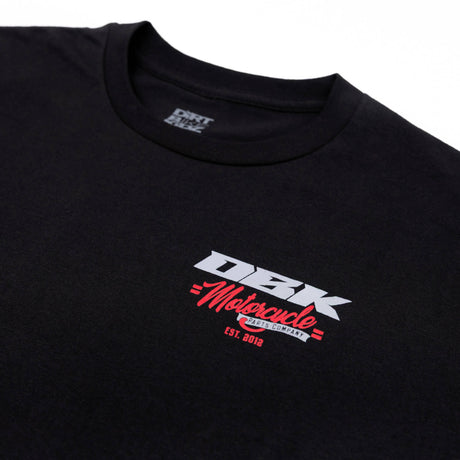 Youth premium T-shirt close-up: black crew neck with DBK Motorcycle chest logo