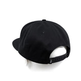 Black snapback cap with adjustable back strap showing dbk branding.