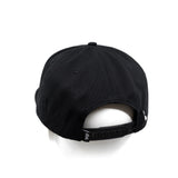 Black snapback cap with curved brim and adjustable strap at back