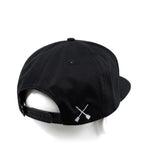 Black snapback cap with white X logo on side and curved brim