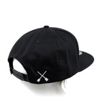 Black snapback cap with X logo near side panel and adjustable back strap