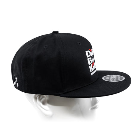 Black snapback cap with white side lettering logo patch and curved brim