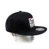 Black snapback cap with white side logo patch, red accents, and curved brim