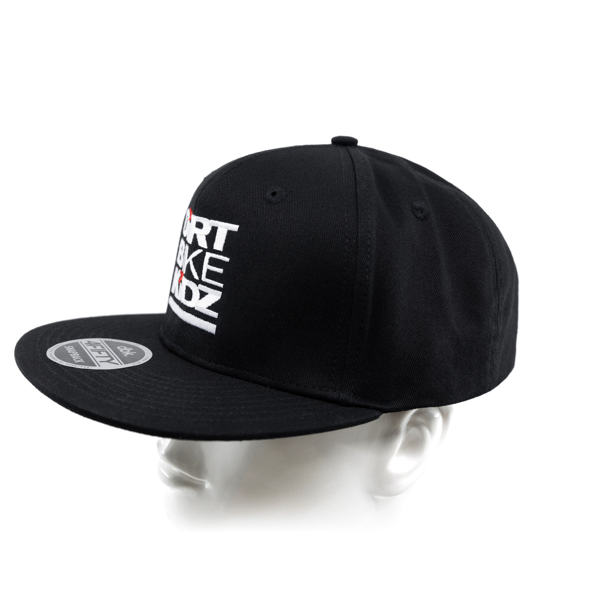 Black snapback cap from side angle with partial front logo graphic.