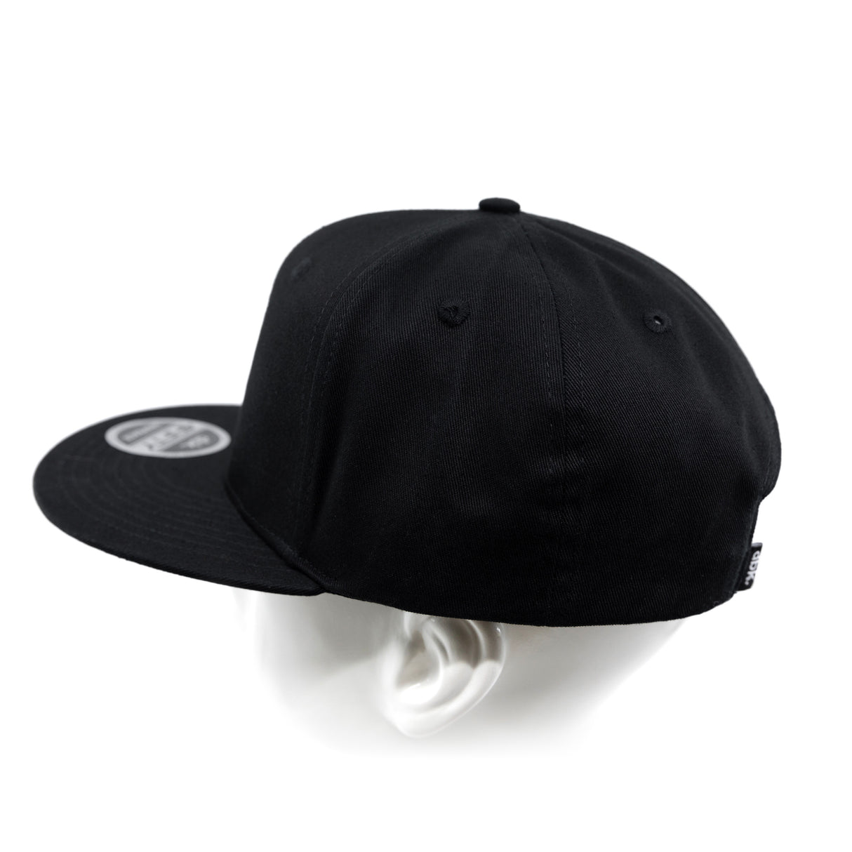 Black snapback cap from back-left angle with side panel and eyelets.
