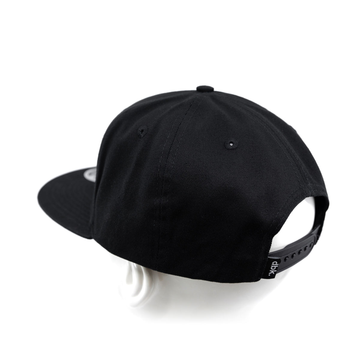 Black snapback cap from back-right angle with adjustable strap panel.