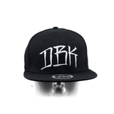Black snapback cap front view on head mannequin with DBK logo and brim patch
