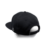Black baseball cap with white crossbones logo and adjustable back strap detail