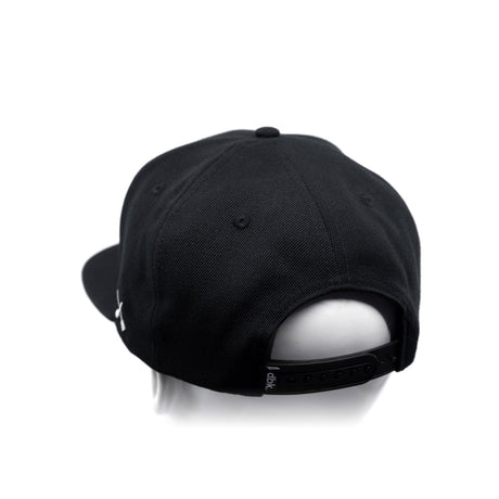 Black baseball cap with adjustable back strap and curved brim, side view