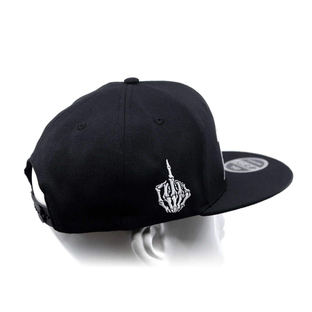 Black snapback cap with curved brim and white hand emblem on side panel