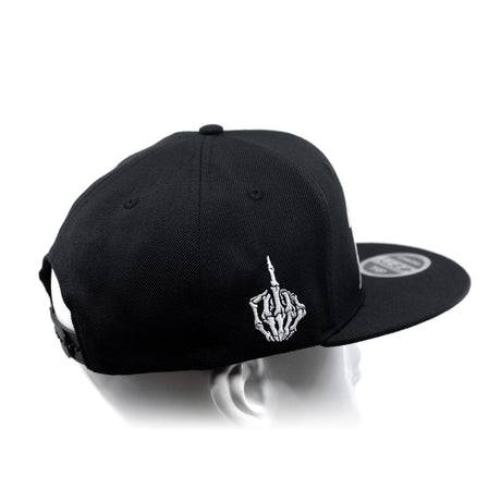 Black snapback cap with curved brim and white hand emblem on side panel