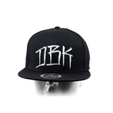 Black snapback cap front view on head mannequin with DBK logo and snapback badge