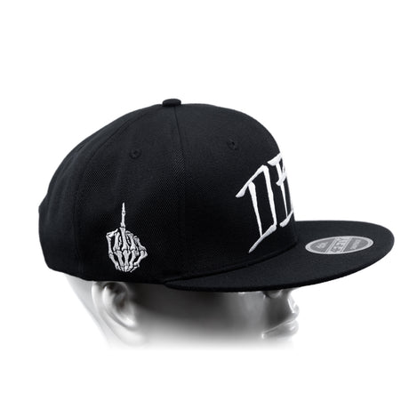 Black snapback cap with curved brim, white hand emblem, and bold side lettering