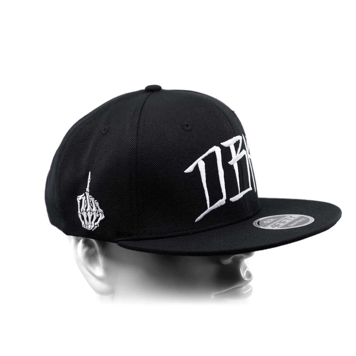 Black snapback cap with curved brim and white side lettering panel detail
