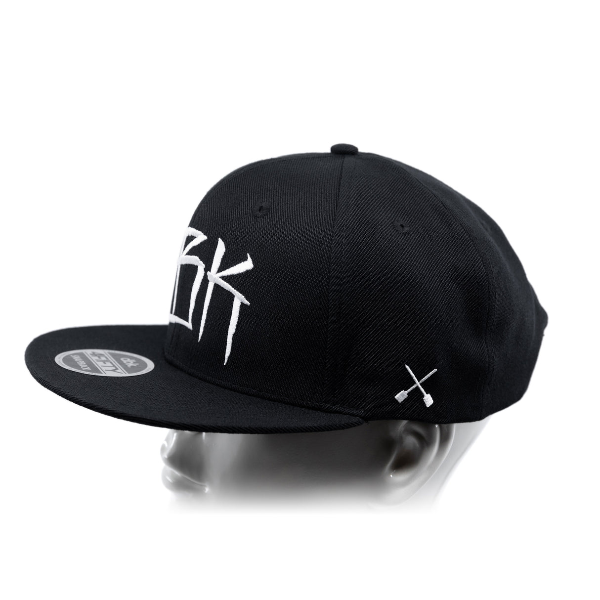 Black baseball cap with white crossbones graphic; side profile view