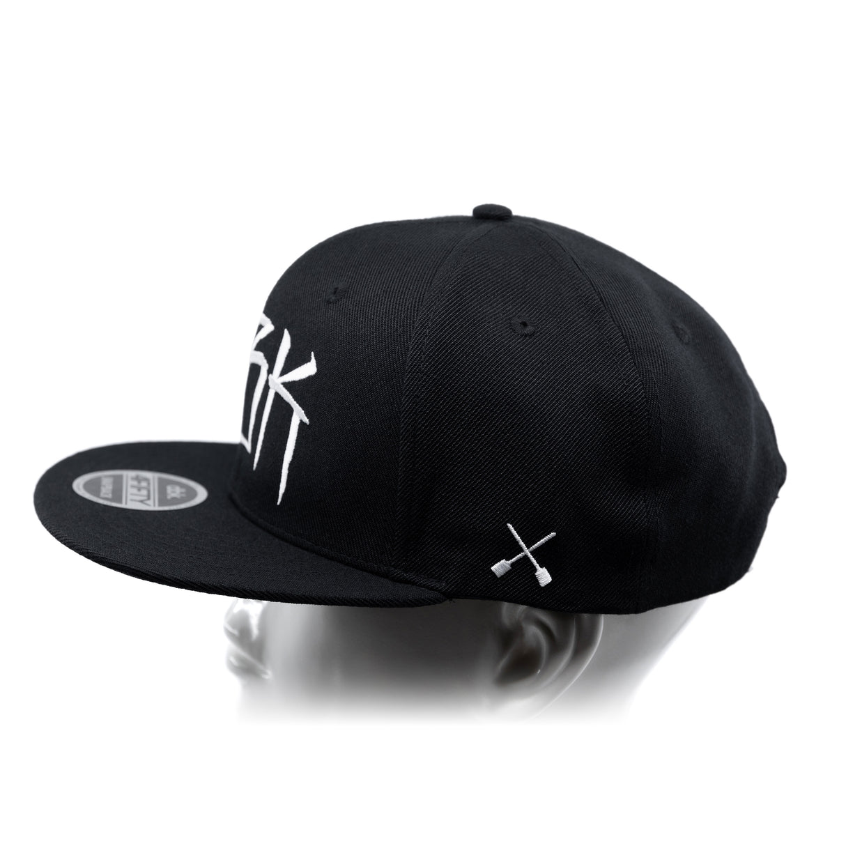 Black baseball cap with white 'DBK' lettering on the side and white crossbones graphic