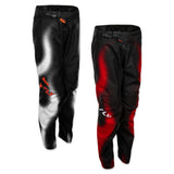Youth motocross pants in black with white graphic panels and orange accents