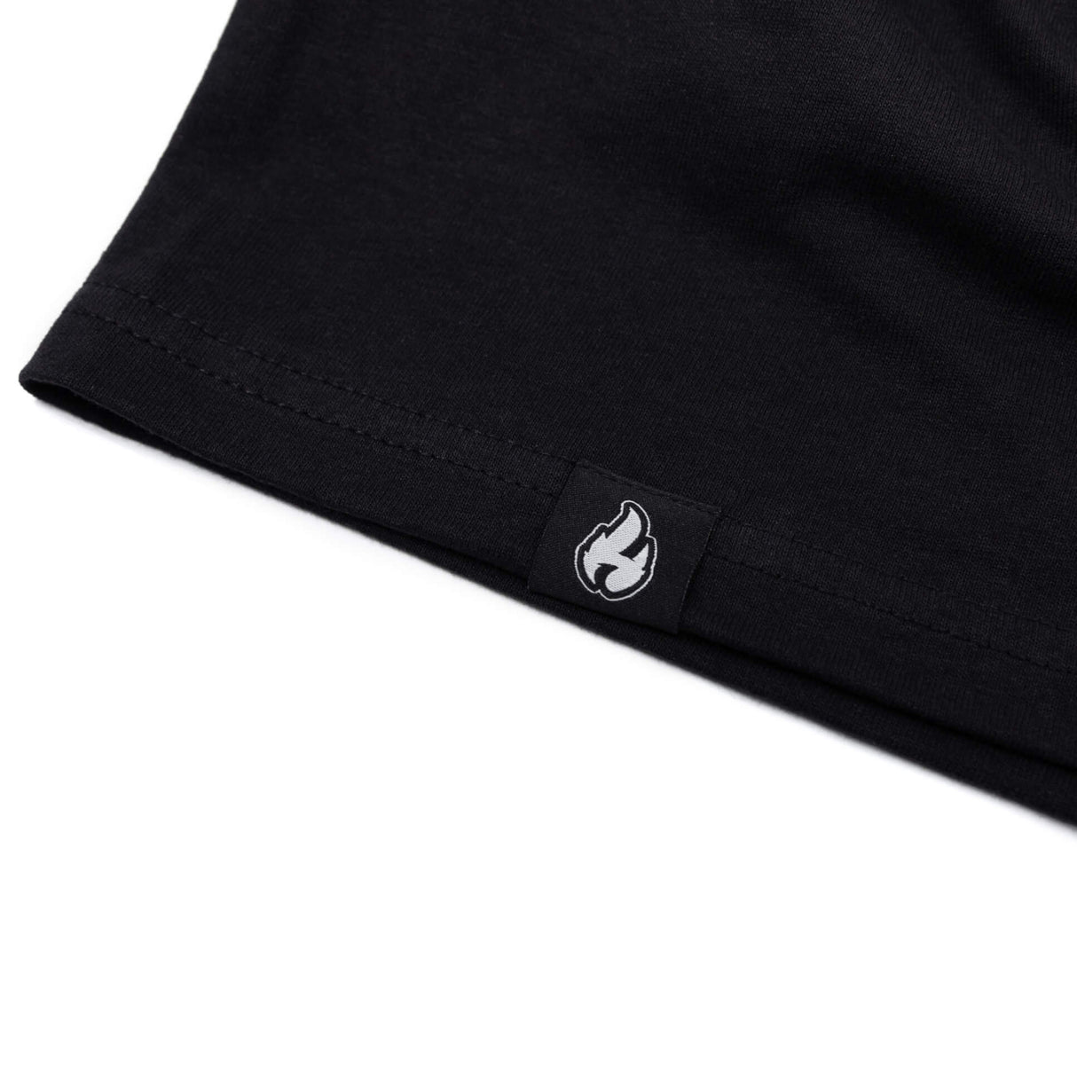 Black T-shirt hem with small flame logo patch