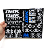 Sticker sheet held in hand with white bike-kidz and dbk logos on black